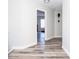 Bright hallway with wood-look floors and access to bedroom at 1074 Berkeley Dr, Kissimmee, FL 34744