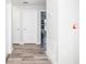 Bright hallway with wood-look flooring and doors to bedrooms at 1074 Berkeley Dr, Kissimmee, FL 34744