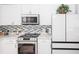 Modern white kitchen with Samsung appliances and wood-look floors at 1074 Berkeley Dr, Kissimmee, FL 34744