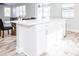 White kitchen island with granite countertop and storage at 1074 Berkeley Dr, Kissimmee, FL 34744