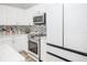 Modern white kitchen with Samsung appliances and wood-look floors at 1074 Berkeley Dr, Kissimmee, FL 34744