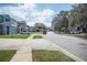 Residential street with two-story houses and lush landscaping at 1074 Berkeley Dr, Kissimmee, FL 34744