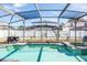 Screened pool and spa with patio and backyard views at 1074 Berkeley Dr, Kissimmee, FL 34744
