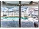 View of the screened-in pool area with lounge chairs at 1074 Berkeley Dr, Kissimmee, FL 34744