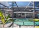 Screened-in pool and spa with paver deck and lounge chairs at 1074 Berkeley Dr, Kissimmee, FL 34744