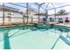 Relaxing pool and spa with a spacious screened enclosure at 1074 Berkeley Dr, Kissimmee, FL 34744