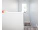 White wall with staircase and wood-look flooring at 1074 Berkeley Dr, Kissimmee, FL 34744