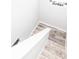 Modern stairs with white railing and wood-look flooring at 1074 Berkeley Dr, Kissimmee, FL 34744