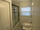 Bright bathroom featuring a glass enclosed shower, vessel sink, and modern fixtures at 1125 S Woodlawn Ave, Bartow, FL 33830