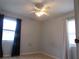 Bedroom with ceiling fan, window with curtains, and light wood-look floors at 1125 S Woodlawn Ave, Bartow, FL 33830