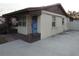 Side view of a light beige house with a blue door and brick accents at 1125 S Woodlawn Ave, Bartow, FL 33830