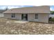 Home's backyard with a patio and open grassy area at 140 Bentley Oaks Blvd, Davenport, FL 33896