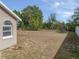 Large backyard with grassy area and partial fence at 140 Bentley Oaks Blvd, Davenport, FL 33896