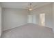 Bright and airy Primary bedroom with double doors leading to bathroom at 140 Bentley Oaks Blvd, Davenport, FL 33896