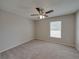 Well-lit bedroom featuring carpet flooring and a large window at 140 Bentley Oaks Blvd, Davenport, FL 33896