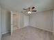Comfortable bedroom with carpet floors and access to a private bathroom at 140 Bentley Oaks Blvd, Davenport, FL 33896