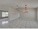 Spacious dining room with a chandelier and tile floor at 140 Bentley Oaks Blvd, Davenport, FL 33896