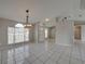 Open dining room with tiled floor and access to kitchen at 140 Bentley Oaks Blvd, Davenport, FL 33896