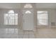 Front entry with tiled floor and two arched windows at 140 Bentley Oaks Blvd, Davenport, FL 33896