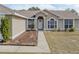 House front view, featuring a walkway and well-maintained lawn at 140 Bentley Oaks Blvd, Davenport, FL 33896