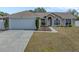 One-story house with attached garage and landscaped yard at 140 Bentley Oaks Blvd, Davenport, FL 33896
