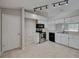 Galley kitchen with stainless steel appliances and white cabinets at 140 Bentley Oaks Blvd, Davenport, FL 33896