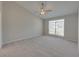 Spacious main bedroom with large window and ceiling fan at 140 Bentley Oaks Blvd, Davenport, FL 33896