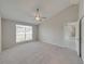 Large main bedroom with vaulted ceiling, window and ceiling fan at 140 Bentley Oaks Blvd, Davenport, FL 33896