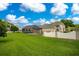 Expansive grassy backyard with a view of the pool and house at 1419 Hollingsworth Oaks Dr, Lakeland, FL 33803