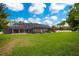 Large backyard with screened pool and lush green lawn at 1419 Hollingsworth Oaks Dr, Lakeland, FL 33803