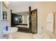 Bathroom with shower, toilet and a white pedestal sink at 1419 Hollingsworth Oaks Dr, Lakeland, FL 33803