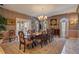 Elegant formal dining room with large table, chandelier, and hardwood floors at 1419 Hollingsworth Oaks Dr, Lakeland, FL 33803