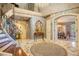 Grand foyer with marble floors, curved staircase, and views to dining room at 1419 Hollingsworth Oaks Dr, Lakeland, FL 33803