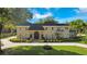 Brick home with a large front yard, circular driveway and mature landscaping at 1419 Hollingsworth Oaks Dr, Lakeland, FL 33803