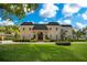 Two-story house with manicured lawn and circular driveway at 1419 Hollingsworth Oaks Dr, Lakeland, FL 33803