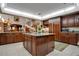 Spacious kitchen with island, granite counters, and wood cabinets at 1419 Hollingsworth Oaks Dr, Lakeland, FL 33803