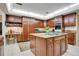Gourmet kitchen featuring wood cabinets, granite counters and large island at 1419 Hollingsworth Oaks Dr, Lakeland, FL 33803