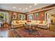 Bright living room with a comfortable sectional sofa and hardwood floors at 1419 Hollingsworth Oaks Dr, Lakeland, FL 33803