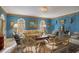 Bright living room with blue walls, ornate furniture, and hardwood floors at 1419 Hollingsworth Oaks Dr, Lakeland, FL 33803