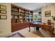 Elegant home office, featuring a large desk and built-in bookshelves at 1419 Hollingsworth Oaks Dr, Lakeland, FL 33803