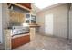 Outdoor kitchen with stainless steel grill, tile, and wood cabinetry at 1419 Hollingsworth Oaks Dr, Lakeland, FL 33803