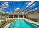 Large, screened pool and patio area with fountains and lush landscaping at 1419 Hollingsworth Oaks Dr, Lakeland, FL 33803