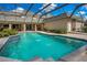 Inviting swimming pool with a screened enclosure and fountain features at 1419 Hollingsworth Oaks Dr, Lakeland, FL 33803