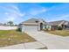 One-story house with gray siding, attached garage, and a well-manicured lawn at 1622 Tressel Ct, Winter Haven, FL 33881