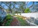 Landscaped backyard with a firepit and mature trees at 1632 Tangerine St, Lakeland, FL 33803