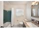 Updated bathroom with teal shower/tub and granite vanity at 1632 Tangerine St, Lakeland, FL 33803