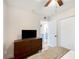 Bedroom with dresser, TV, and access to bathroom at 1632 Tangerine St, Lakeland, FL 33803