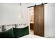 Bedroom with barn door leading to bathroom at 1632 Tangerine St, Lakeland, FL 33803