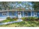 Updated mid-century ranch home with light blue paint and landscaping at 1632 Tangerine St, Lakeland, FL 33803