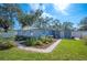 Newly painted home with a side yard and landscaping at 1632 Tangerine St, Lakeland, FL 33803